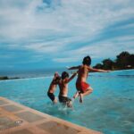 three boy s jumping into the water