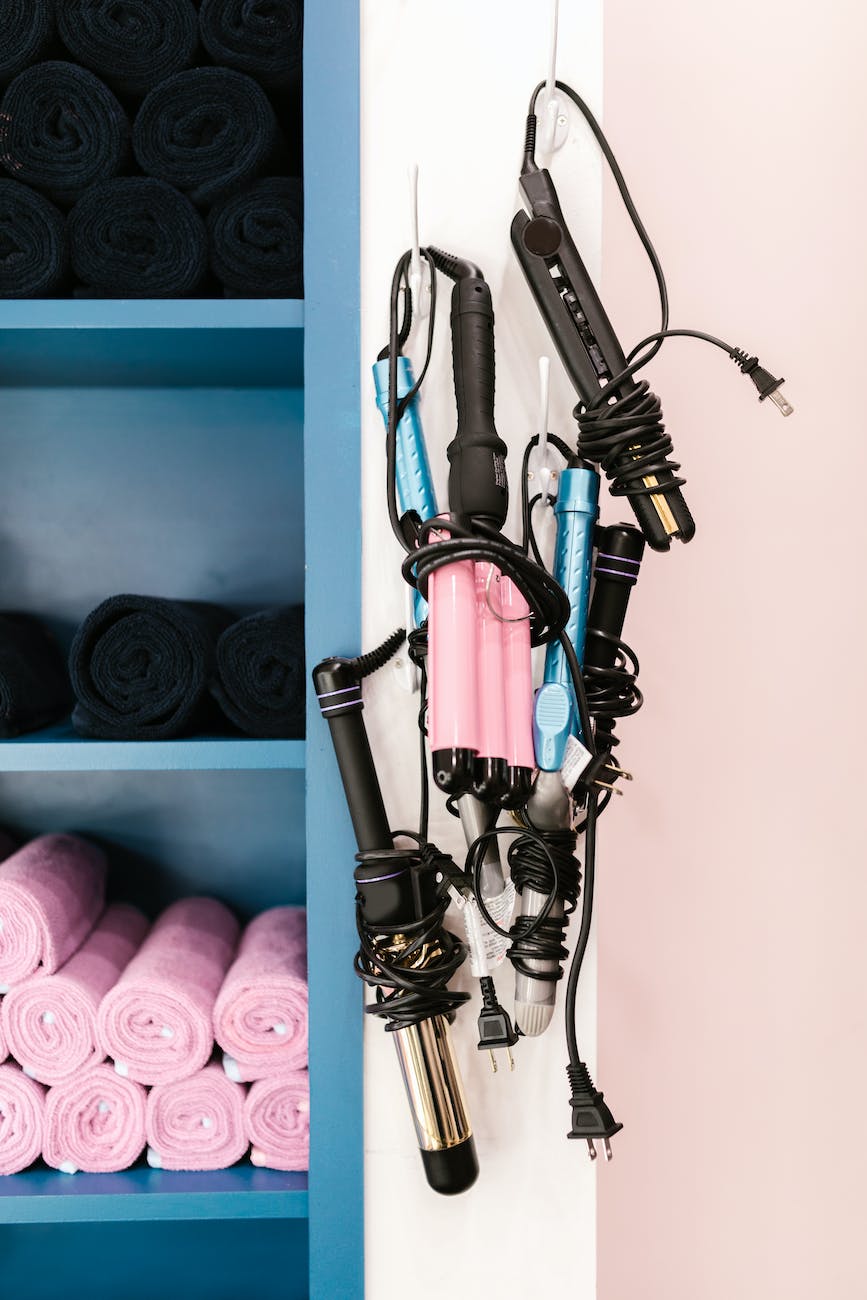 close up shot of curling irons hanging on the wall