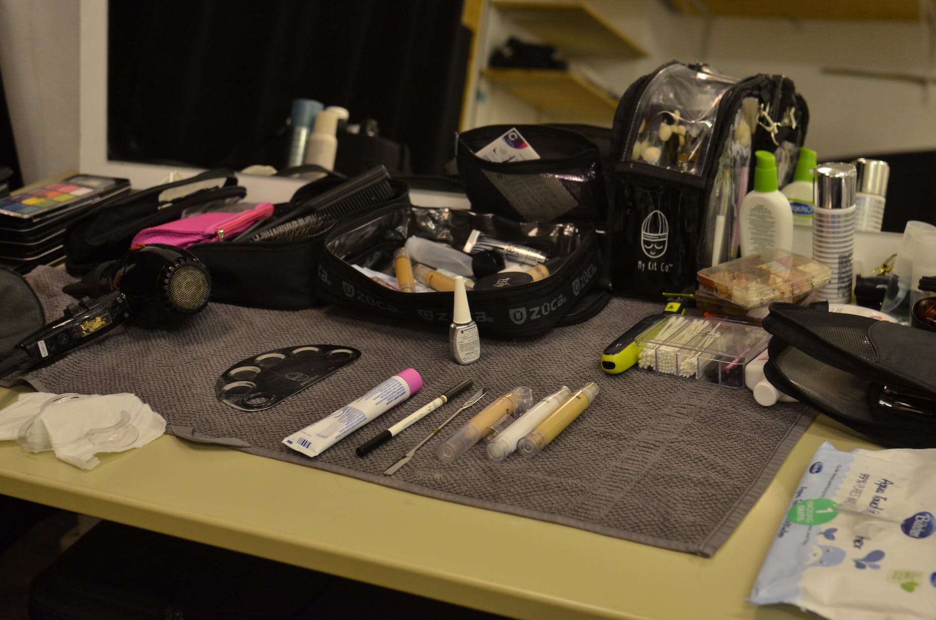 set of various cosmetic products arranged on table in beauty salon